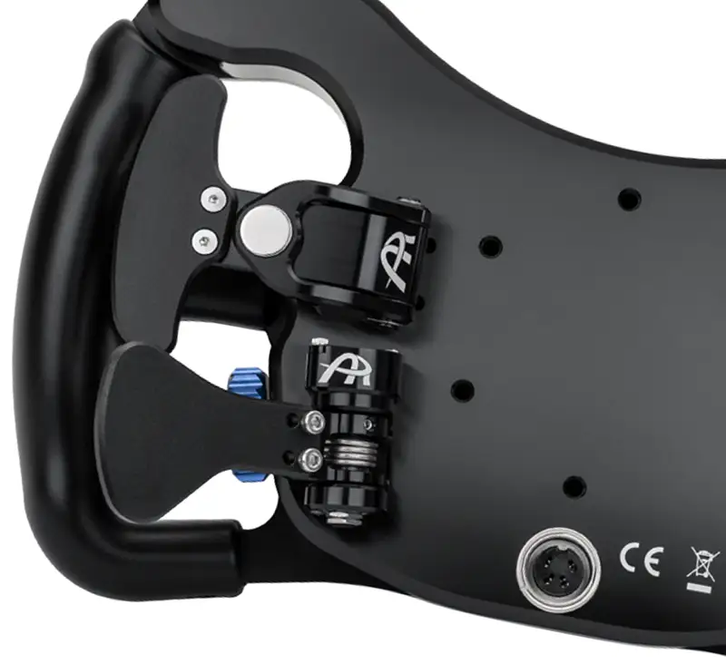 Back of a sim racing steering wheel showing clutch paddles and magnetic shifters. The wheel is black with rubber handle, photographed on a white background