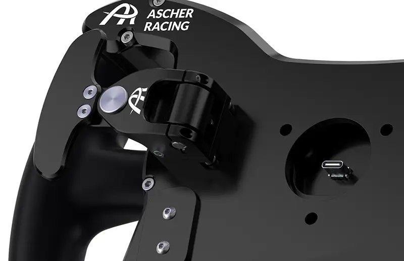 Rear photo that's cropped showing the detail of the Ascher Artura GT4 McLaren approved, silenced single or double magnetic shifters and clutch paddles. The image is black with a white background