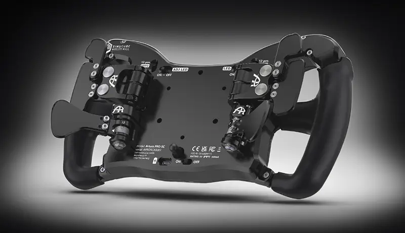 Rear photo of the back of a black sim racing wheel showing the black paddle shifters and all the silver screws. It is against a dark grey background. The Ascher McLaren Artura Pro chassis featuring pre-drilled holes and a thoughtful design with gen 6 paddles