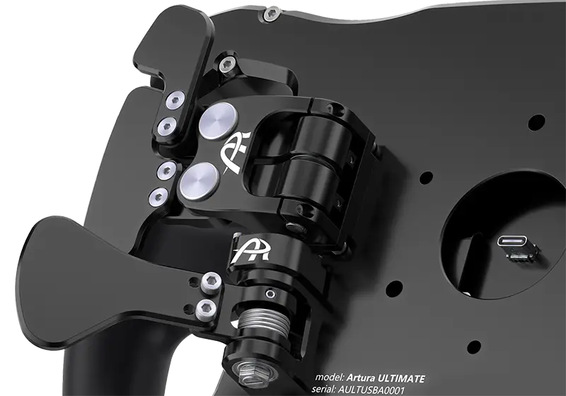 Cropped photo showing detail of the McLaren approved silenced single and double magnetic shifters. They are black alloy and there is AR logos on it in white. You can closely see the engineering and fixing bolts. The background is white.